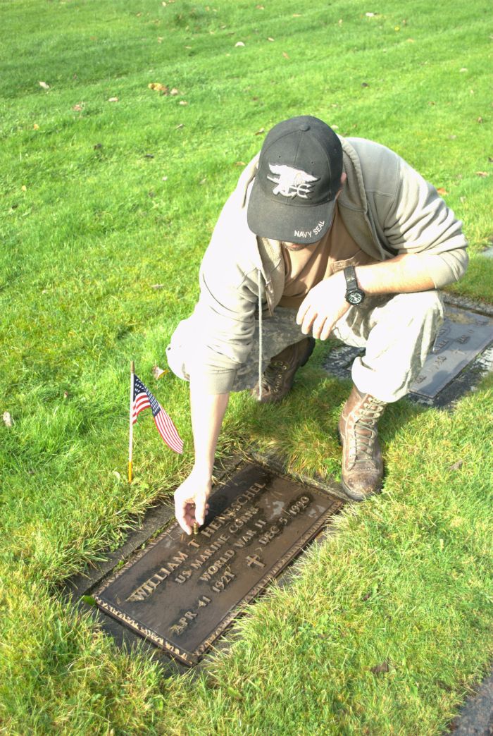 Hubby putting bullet on his Grandpa's Headstone for Veteran's Day